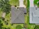 An aerial view of a home with a well-maintained roof and beautiful landscaping at 2881 Manor Downs, The Villages, FL 32162