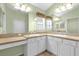 Bathroom featuring double sinks, vanity, and neutral color palette at 2881 Manor Downs, The Villages, FL 32162