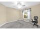 An empty bedroom with a ceiling fan and a window with light-filtering blinds at 2881 Manor Downs, The Villages, FL 32162