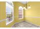 Cozy dining area featuring arched windows and a modern chandelier fixture at 2881 Manor Downs, The Villages, FL 32162