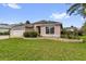 Charming single-story home featuring a two-car garage and well-manicured lawn at 2881 Manor Downs, The Villages, FL 32162