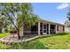 Exterior view of the screened in patio with well-maintained landscaping at 2881 Manor Downs, The Villages, FL 32162
