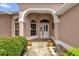 Inviting front entrance with stone pathway, potted plants, and decorative accents at 2881 Manor Downs, The Villages, FL 32162