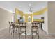 Open concept kitchen with breakfast bar, stainless appliances, and tile flooring at 2881 Manor Downs, The Villages, FL 32162