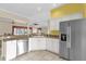 Bright kitchen with white cabinetry, stainless steel appliances, and tile flooring at 2881 Manor Downs, The Villages, FL 32162