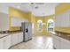 Eat-in kitchen featuring stainless appliances, white cabinetry and large tile flooring at 2881 Manor Downs, The Villages, FL 32162