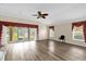 Spacious living room with hardwood floors, ample natural light, and neutral paint at 2881 Manor Downs, The Villages, FL 32162