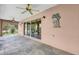 A covered patio with decorative wall art and ceiling fans at 2881 Manor Downs, The Villages, FL 32162