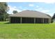Large, screened-in porch with spacious backyard, ideal for relaxing and entertaining guests at 31104 Fairvista Dr, Tavares, FL 32778