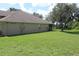 Expansive backyard with lush green grass and mature trees, perfect for outdoor activities at 31104 Fairvista Dr, Tavares, FL 32778