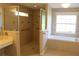 Well-lit bathroom featuring a spacious shower with glass doors and a separate soaking tub for relaxation at 31104 Fairvista Dr, Tavares, FL 32778