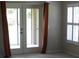 Cozy bedroom with private access to patio and features bright windows with custom shutters at 31104 Fairvista Dr, Tavares, FL 32778
