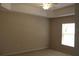 Bedroom with a ceiling fan, window, neutral walls, and carpeted floor at 31104 Fairvista Dr, Tavares, FL 32778