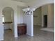 Open dining room features an elegant chandelier and flows into kitchen and living areas at 31104 Fairvista Dr, Tavares, FL 32778