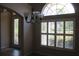 Bright entryway features a decorative front door and a large window with plantation shutters at 31104 Fairvista Dr, Tavares, FL 32778