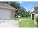 Home exterior featuring a paved driveway, attached garage, and well-maintained landscaping at 31104 Fairvista Dr, Tavares, FL 32778