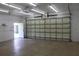 Spacious garage interior with lighting and an open door to the outside at 31104 Fairvista Dr, Tavares, FL 32778