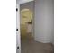 View from the hallway into a bright kitchen with breakfast bar and tile floors at 31104 Fairvista Dr, Tavares, FL 32778