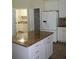 Well-equipped kitchen with a granite island and stainless steel refrigerator at 31104 Fairvista Dr, Tavares, FL 32778