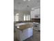 Spacious kitchen featuring granite countertops, an island, stainless steel appliances, and ample cabinet space at 31104 Fairvista Dr, Tavares, FL 32778