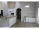 Open-concept kitchen with granite counters, stainless appliances, and seamless connection to the dining area at 31104 Fairvista Dr, Tavares, FL 32778