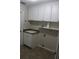 Bright laundry room with sink, cabinets, and ample counter space for folding at 31104 Fairvista Dr, Tavares, FL 32778