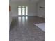 Spacious living room boasts tile flooring and sliding glass doors to the backyard at 31104 Fairvista Dr, Tavares, FL 32778