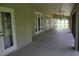 Covered patio with tiled flooring, multiple access points, and a neutral color scheme for seamless indoor-outdoor living at 31104 Fairvista Dr, Tavares, FL 32778
