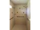 Accessible shower with multiple shower heads, grab bars and convenient corner shelves at 31104 Fairvista Dr, Tavares, FL 32778