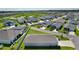 An aerial view of a quiet community with a scenic water view, featuring well-maintained homes and landscaping at 3283 Dawn Pl, The Villages, FL 32163