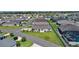 Aerial view showcasing a well-maintained neighborhood with lush greenery and blue-accented single-story homes at 3283 Dawn Pl, The Villages, FL 32163