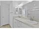 Bathroom featuring double sinks, a large mirror, sleek fixtures, and a glass-enclosed shower at 3283 Dawn Pl, The Villages, FL 32163