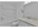 Clean bathroom features a shower-tub combo, a single sink vanity, and ample lighting at 3283 Dawn Pl, The Villages, FL 32163