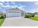 Charming single-story home with well-manicured lawn and a two-car garage at 3283 Dawn Pl, The Villages, FL 32163