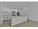 Well-equipped kitchen with stainless steel appliances, a spacious island, and sleek white cabinetry for a modern look at 3283 Dawn Pl, The Villages, FL 32163