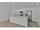 Bright kitchen features stainless steel appliances, white cabinetry, and a spacious center island, perfect for cooking and entertaining at 3283 Dawn Pl, The Villages, FL 32163