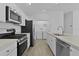 Well-equipped kitchen includes stainless steel appliances and plenty of cabinet space with easy access to the laundry area at 3283 Dawn Pl, The Villages, FL 32163