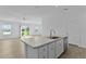 Bright, open-concept kitchen featuring a large island with stainless steel appliances and modern finishes at 3283 Dawn Pl, The Villages, FL 32163