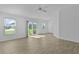 Bright living room featuring wood-look floors, sliding glass doors and lots of natural light at 3283 Dawn Pl, The Villages, FL 32163