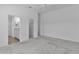 Spacious main bedroom featuring an ensuite bathroom, walk-in closet, ceiling fan, and neutral carpeting at 3283 Dawn Pl, The Villages, FL 32163