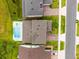 Aerial view of a home showcasing the pool and surrounding manicured landscaping at 3304 Canna Lily Pl, Clermont, FL 34711