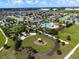 Overhead shot of community amenities, including a pool, clubhouse, playground, and green spaces at 3304 Canna Lily Pl, Clermont, FL 34711