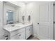 A well-lit bathroom featuring double sinks, white cabinetry, and a clean, modern design at 3304 Canna Lily Pl, Clermont, FL 34711