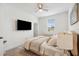 A modern bedroom with a plush bed, TV, neutral color palette, and cozy ambiance for restful nights at 3304 Canna Lily Pl, Clermont, FL 34711