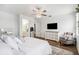 Tranquil bedroom featuring a spacious layout, plush bedding, and a view into the bathroom at 3304 Canna Lily Pl, Clermont, FL 34711