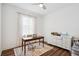 Bright bedroom featuring a desk, stylish rug, and a white dresser with decor, illuminated by a modern ceiling fan at 3304 Canna Lily Pl, Clermont, FL 34711