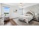 Serene bedroom with a decorative accent wall, plush bedding, and water views from the windows at 3304 Canna Lily Pl, Clermont, FL 34711