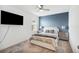 Cozy bedroom with a ceiling fan, TV, and complementary bedside lamps for a luxurious aesthetic at 3304 Canna Lily Pl, Clermont, FL 34711