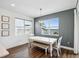 Dining area with modern chandelier, ample natural light, and view of the water at 3304 Canna Lily Pl, Clermont, FL 34711