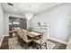 Bright dining room featuring stylish chandelier, fireplace with decor, and view of the adjacent living space at 3304 Canna Lily Pl, Clermont, FL 34711